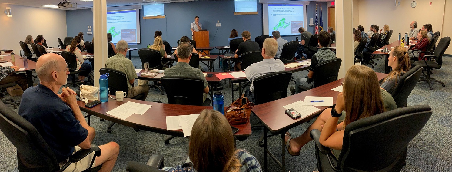 Conference room with rows of participants watching a presentation