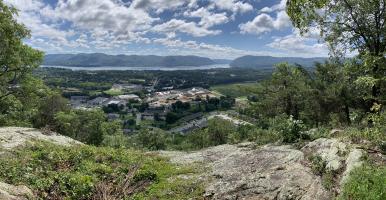 View of the Hudson River and Highlands beyond, from a rocky ledge.