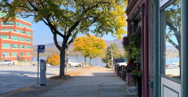 sidewalk with shade from street tree and view of Hudson River in the distance