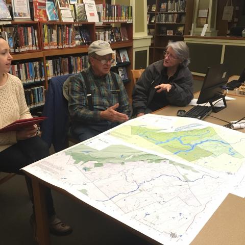 Town of Gardiner volunteers gather around a map on a table. Photo by Nate Nardi-Cyrus