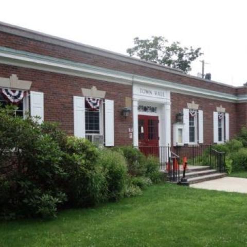 Front of Town Hall in Rhinebeck, NY, a brick building with flagpole in front.